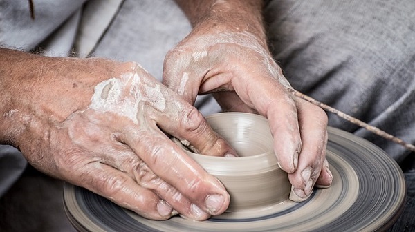 someone making a handmade clay pot